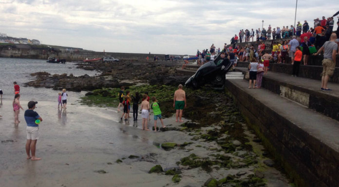 Empty auto  rolls down steps into busy Co Clare beach