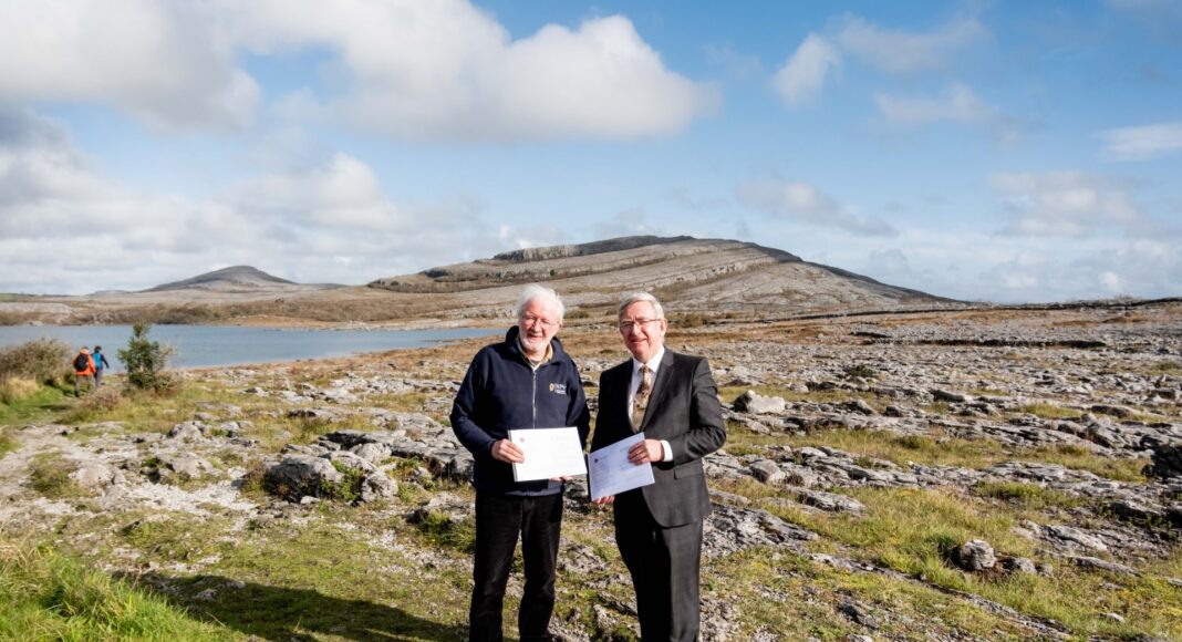 Minister for Nature, Heritage and Electoral Reform, Malcolm Noonan T.D., and President of University of Galway, Professor Ciarán Ó hÓgartaigh walk the iconic landscape of The Burren after signing the agreement between the NPWS and the University of Galway.
